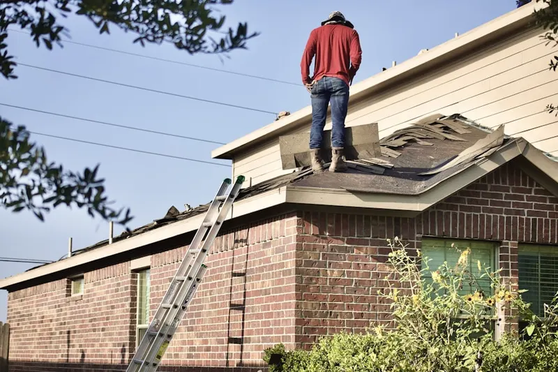 Professional roofer working on a residential roof in Farmers Mills